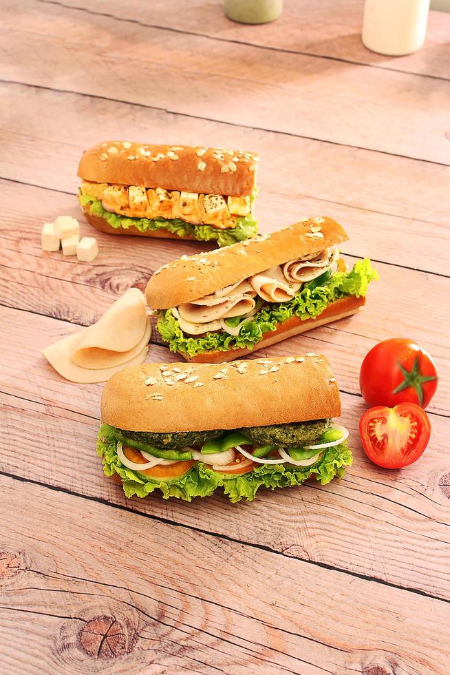 Submarine sandwiches on a wooden background photo