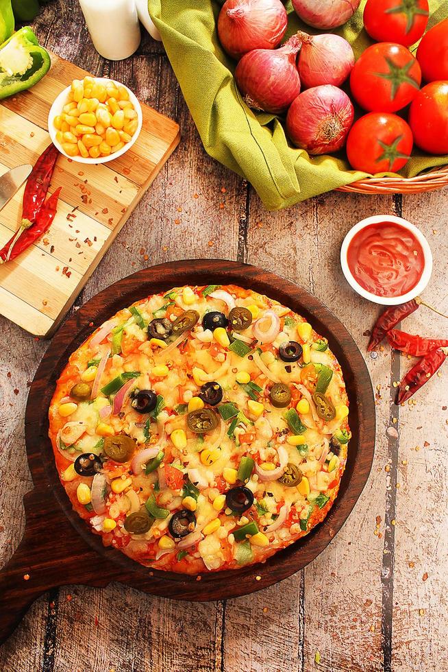 Vegetarian pizza with wooden background photo