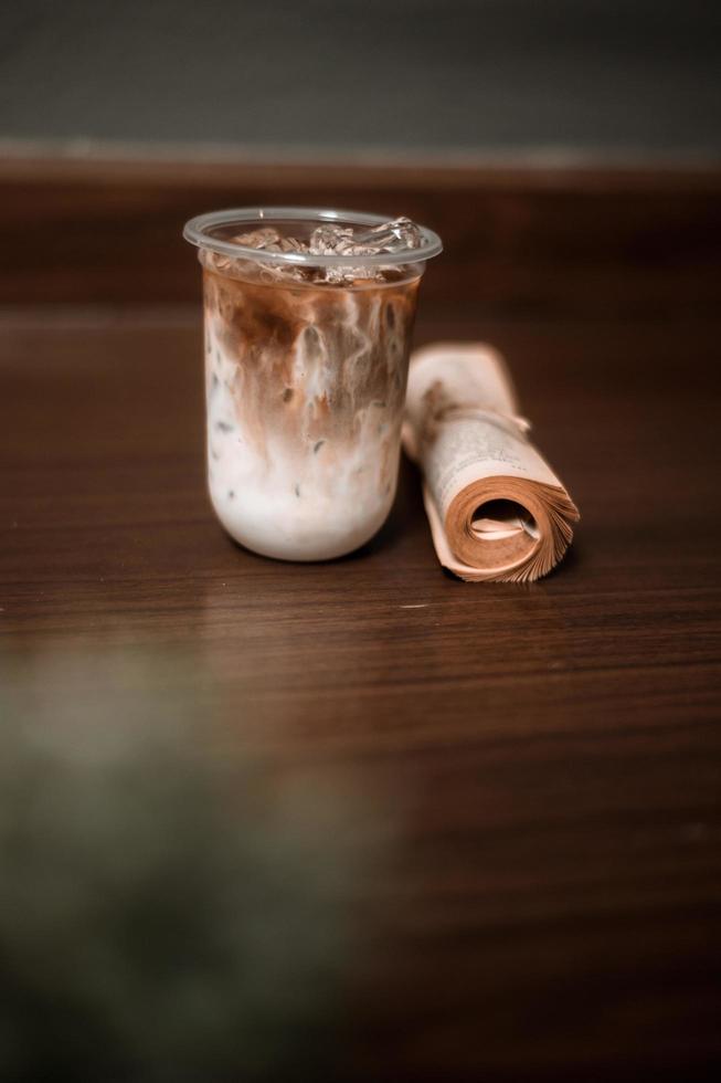 Glass of coffee with milk on the table photo