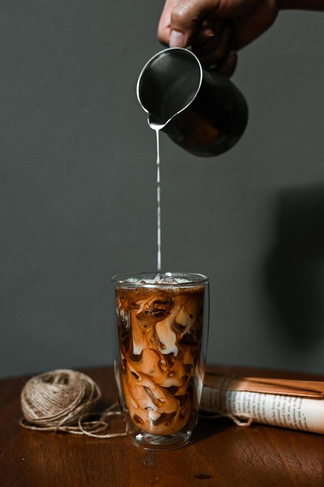 Glass of coffee with milk on the table photo