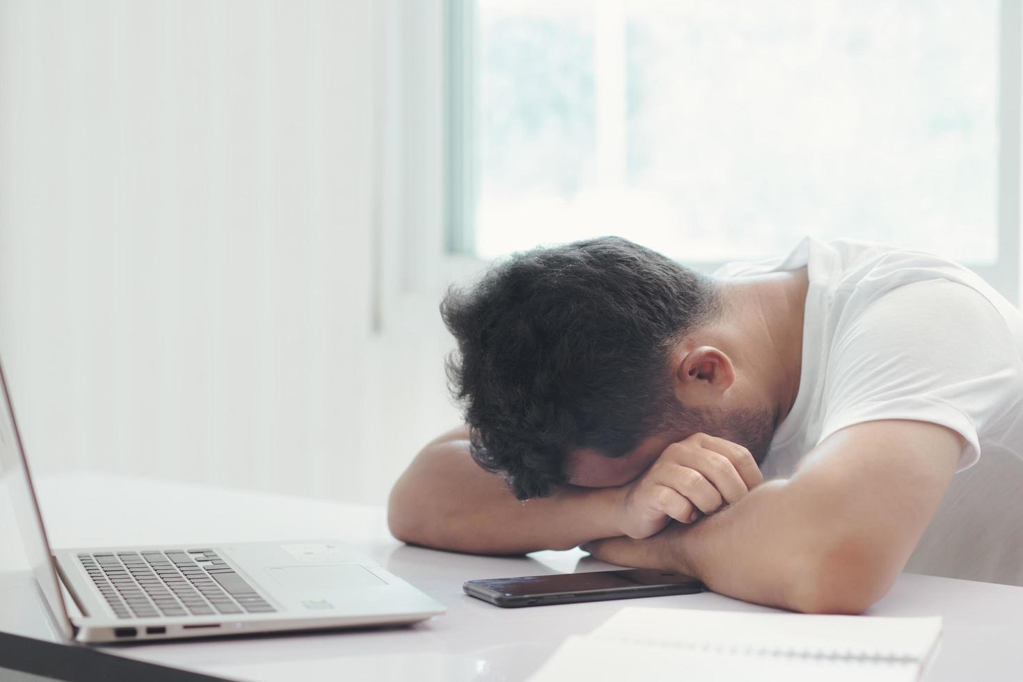 The employee is sitting stressed out with his job photo