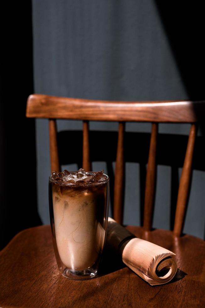 Glass of coffee with milk on the table photo