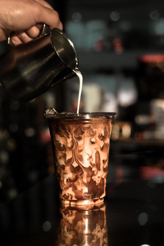 Glass of coffee with milk on the table photo