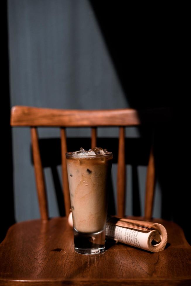 Glass of coffee with milk on the table photo