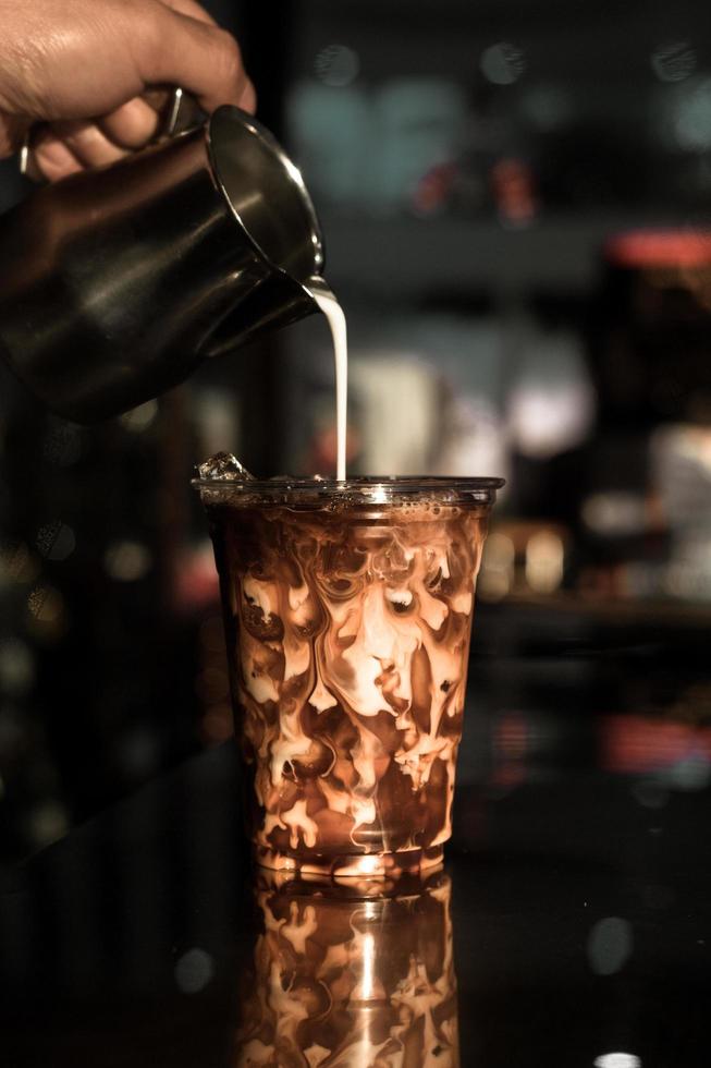 Glass of coffee with milk on the table photo