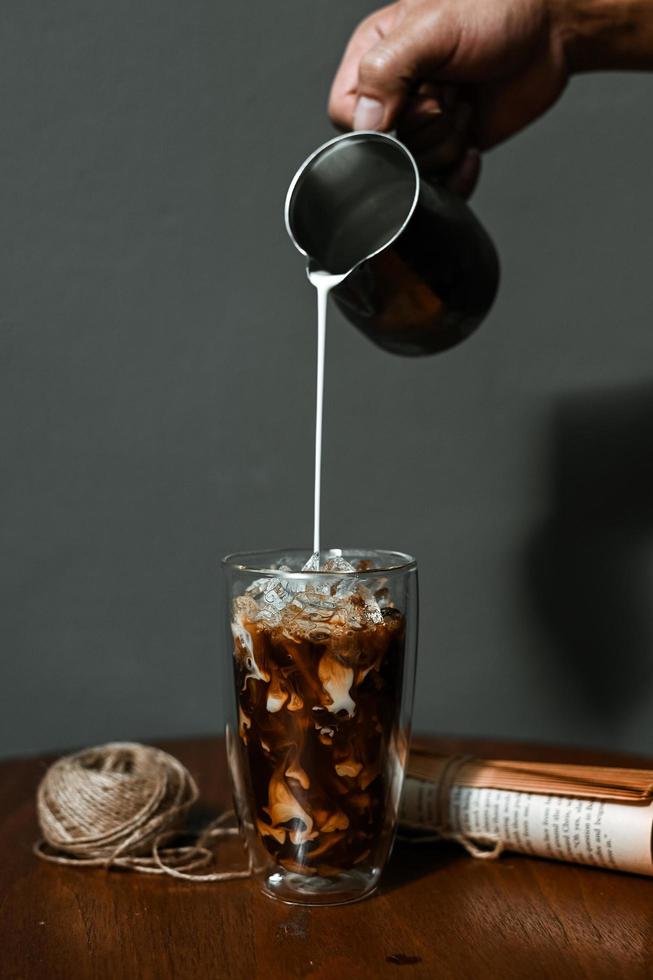 Glass of coffee with milk on the table photo