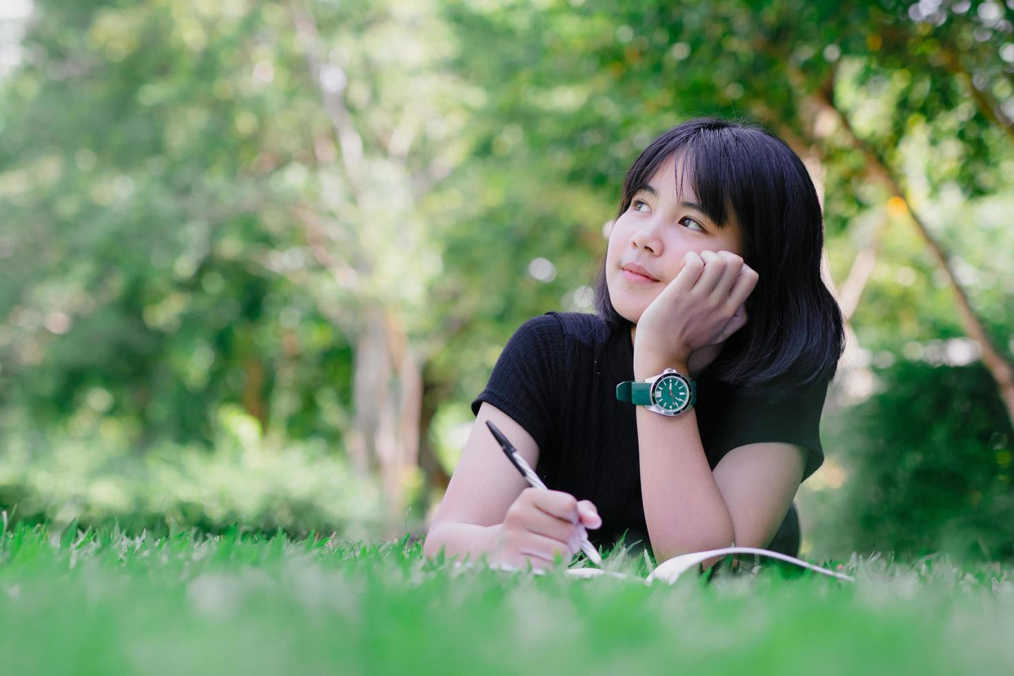 Girl sitting in the garden thinking thinking photo