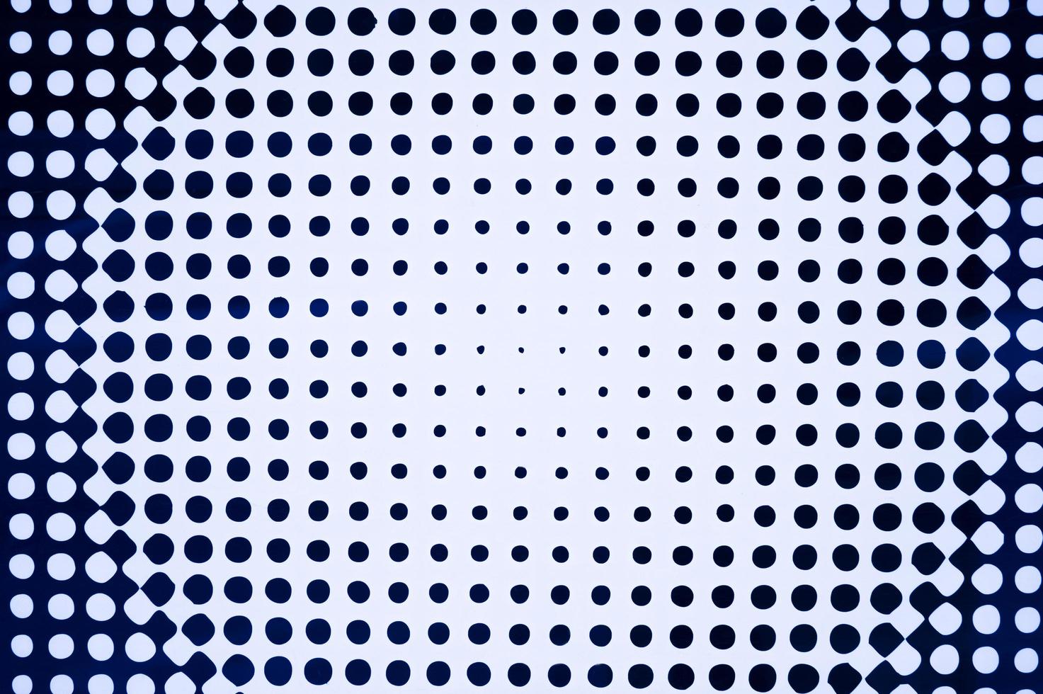 The texture of a white background with black circles of different sizes photo