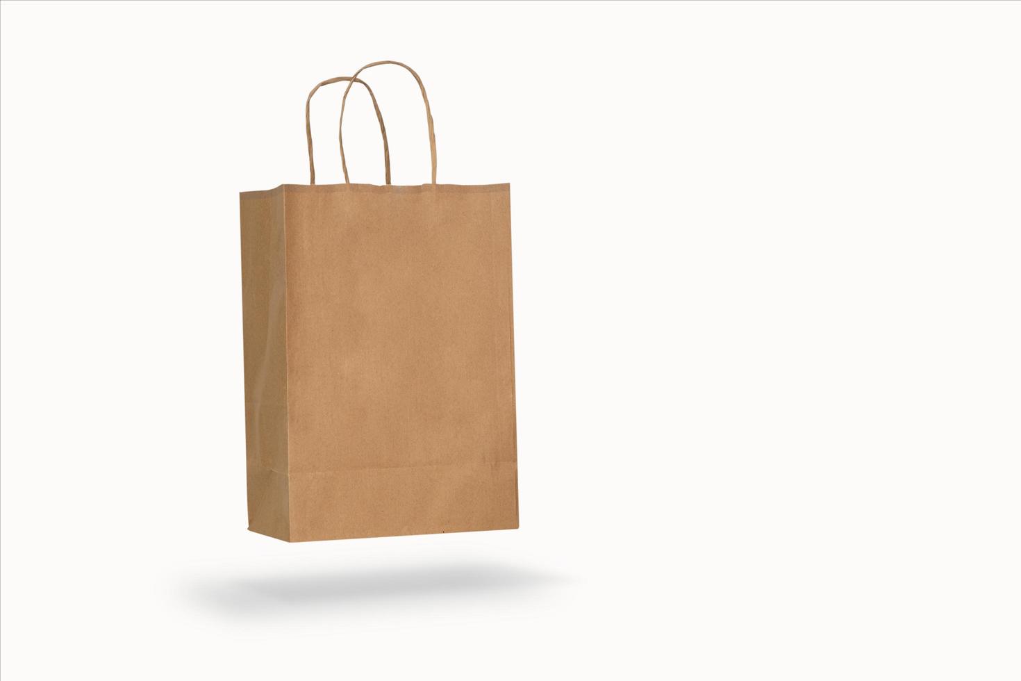 Mockup of a recycled craft paper bag isolated on a white background photo