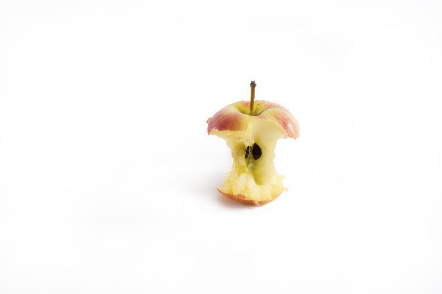 Red apple missing a bite isolated on white background photo