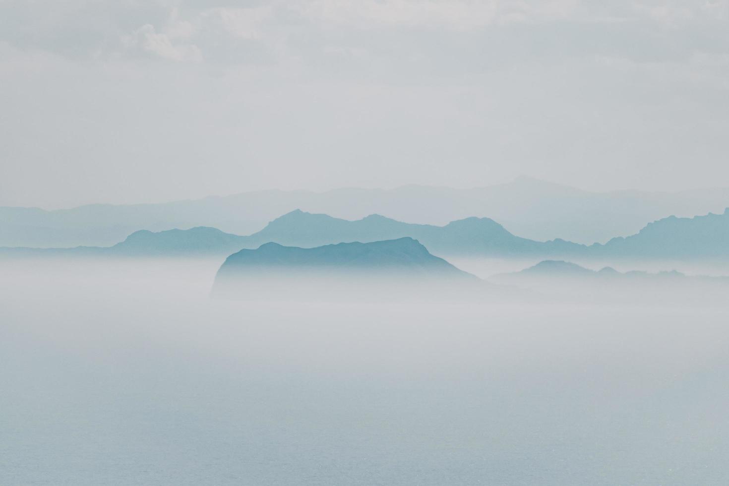 Foggy mountain under gray sky photo
