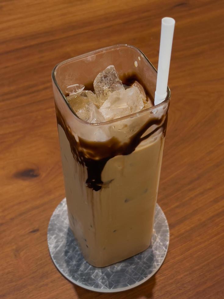 Iced coffee on wooden table photo