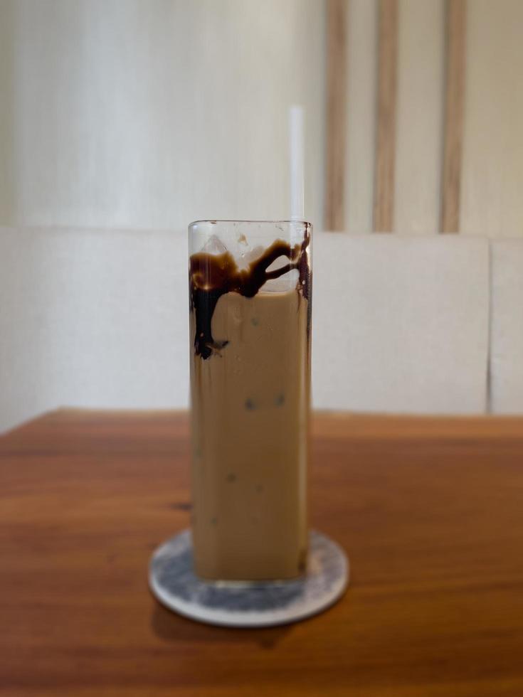 Iced coffee on wooden table photo