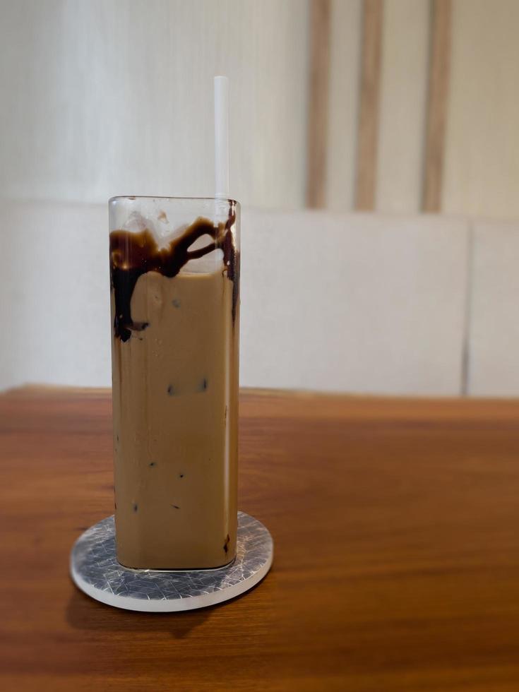 Iced coffee on wooden table photo