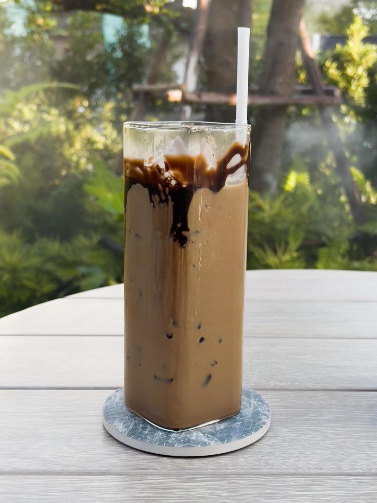 Iced coffee on wooden table photo