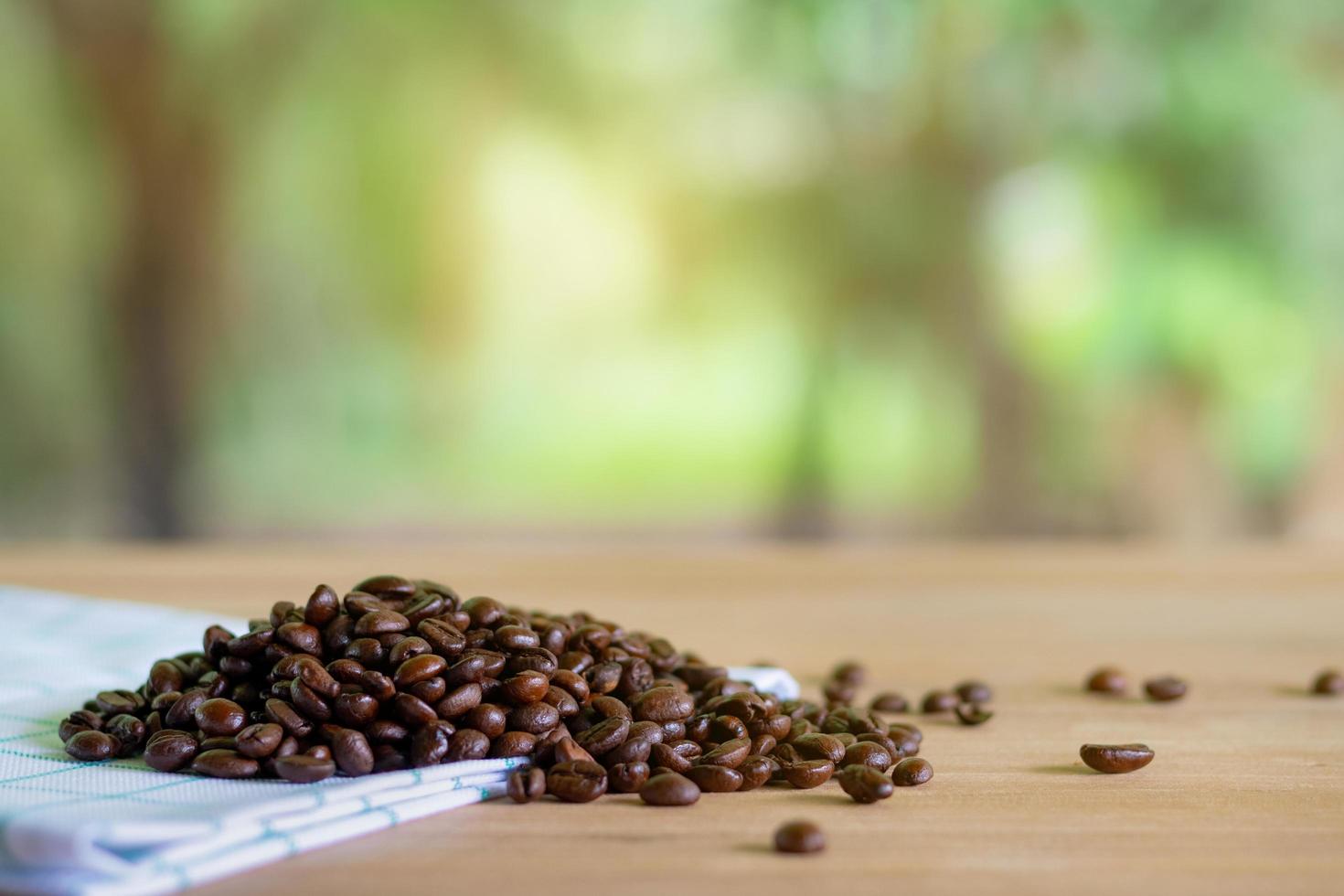 Roasted coffee beans on wooden background photo