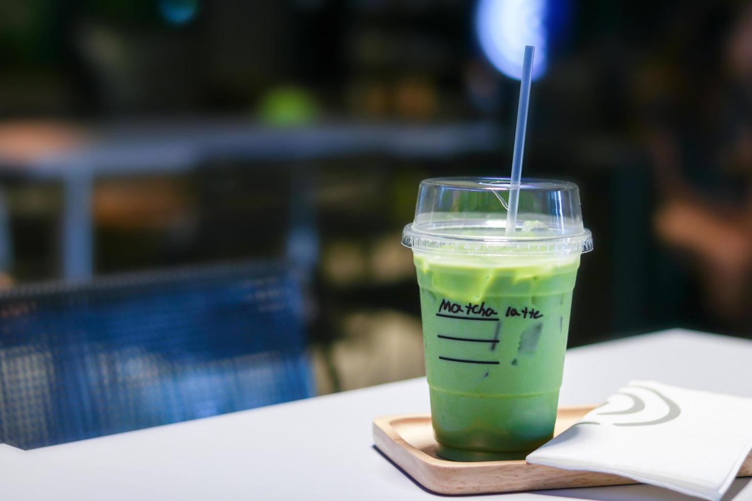 Iced matcha green tea latte on table photo