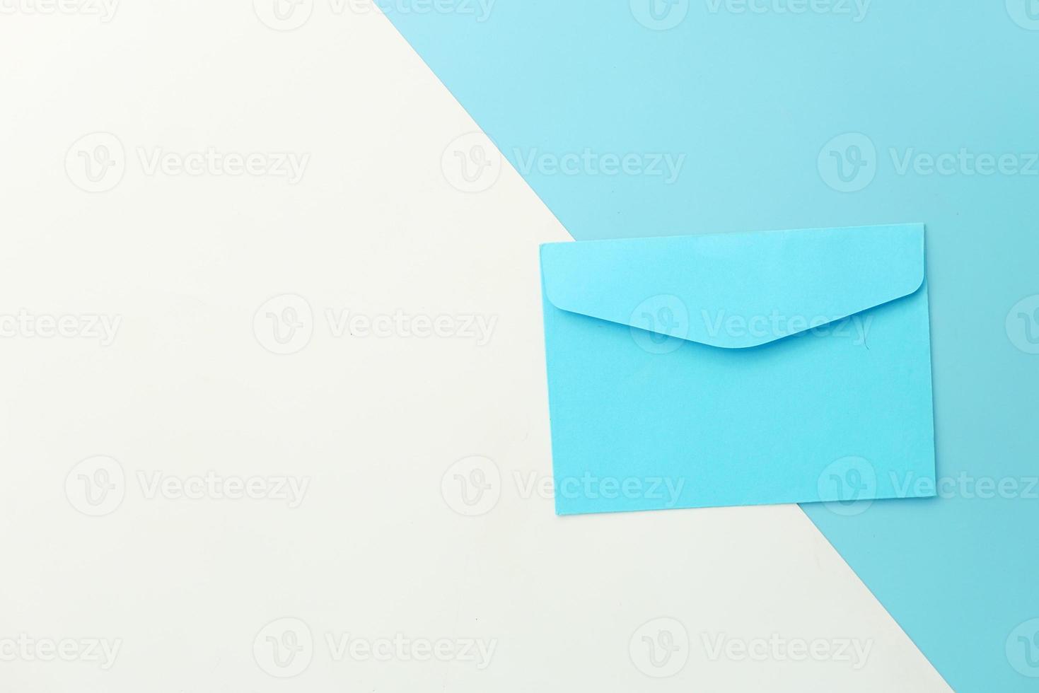 Blue envelope on white and blue background with copy space photo