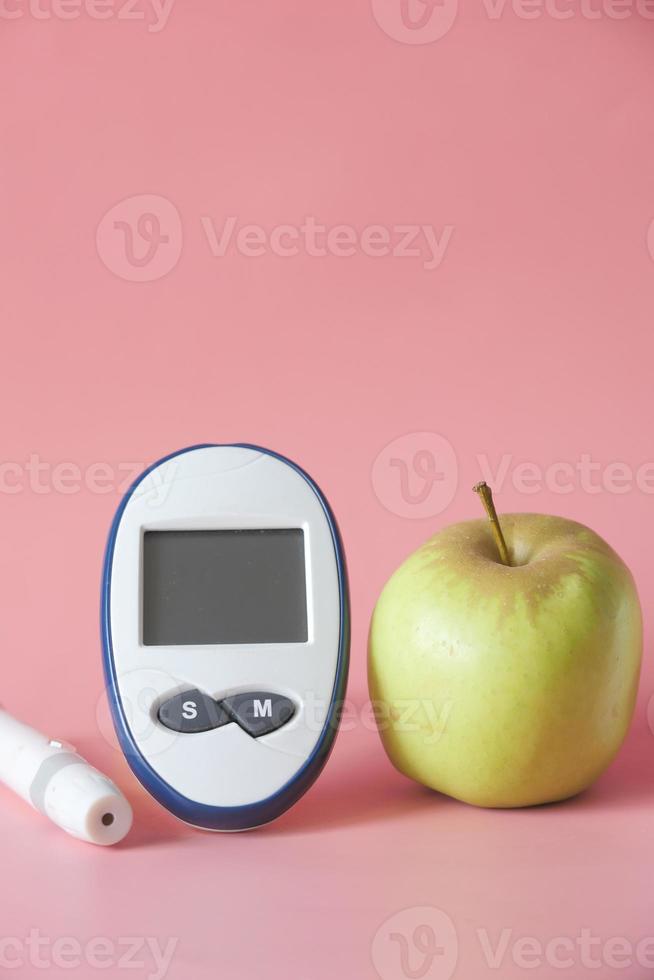 Herramientas de medición para diabéticos con manzana en la mesa foto