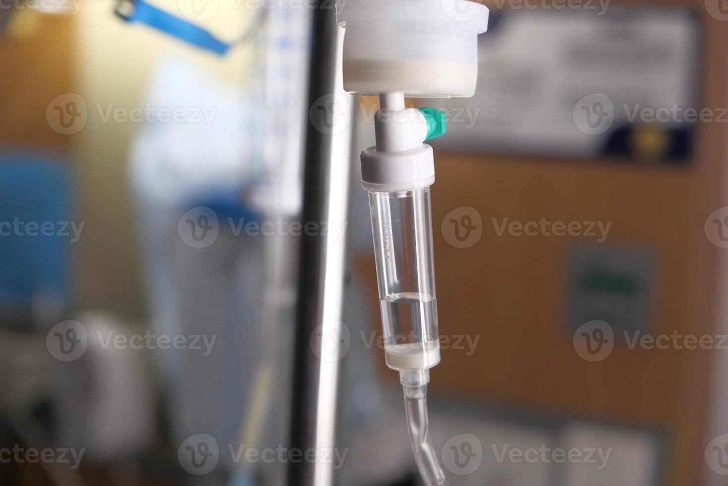 Saline solution dripping in hospital room photo