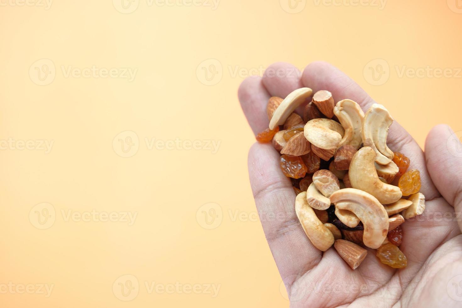 Mixed nuts in hand with copy space photo