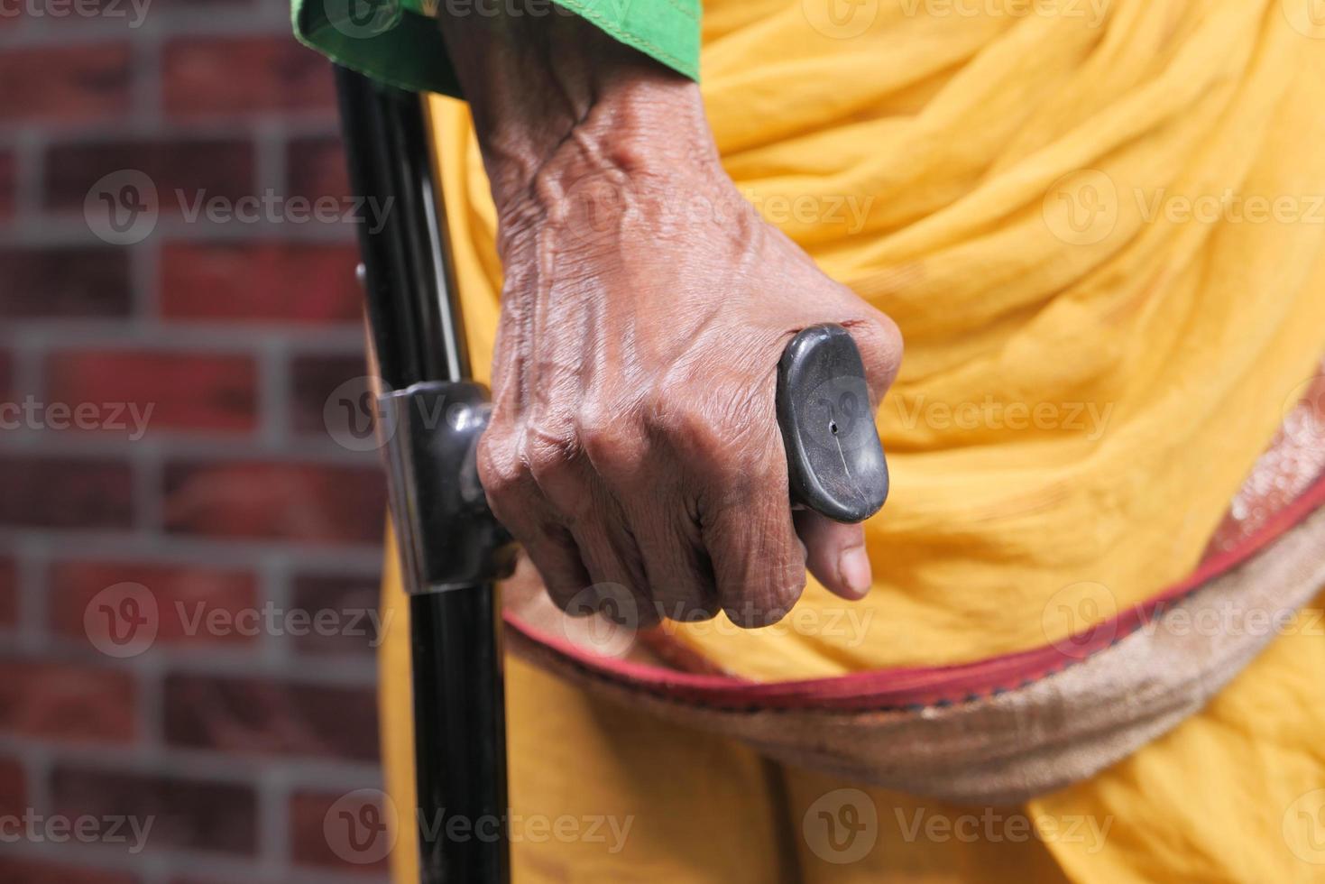 Senior Asian woman using crutches photo