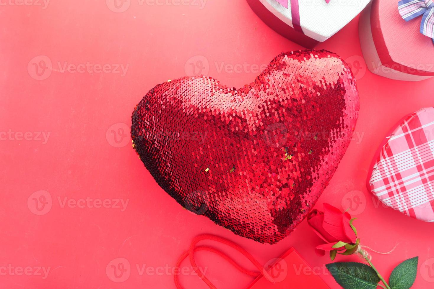 Heart shaped gift on red background photo