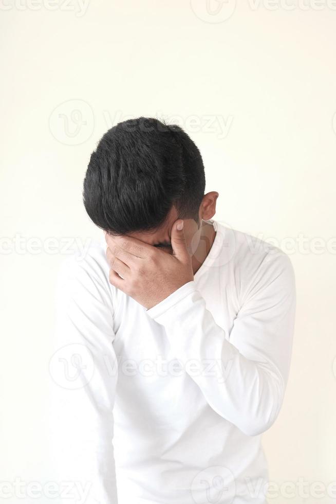 Young man cover his face photo