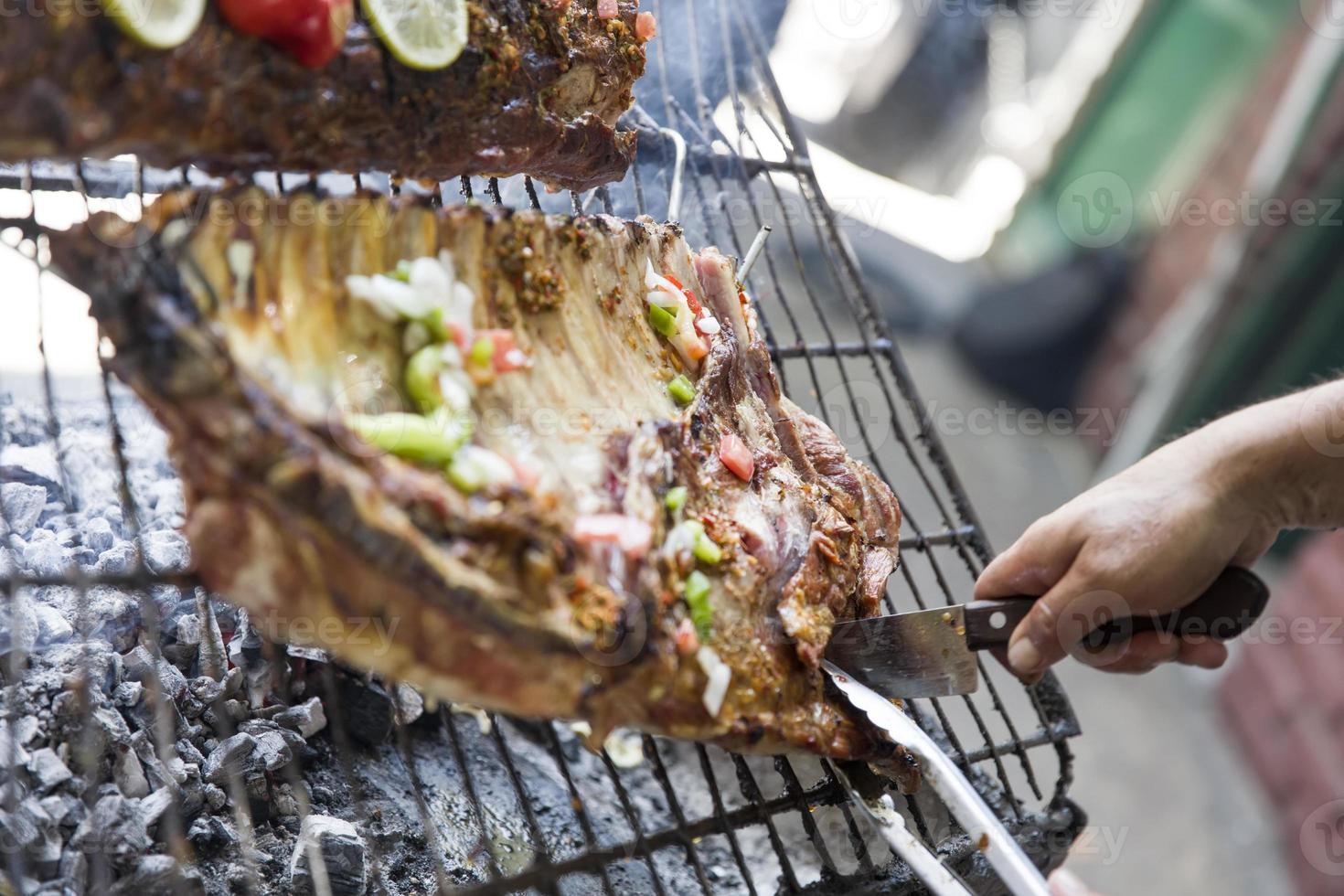 Roasted meat cooked on an outdoor grill photo