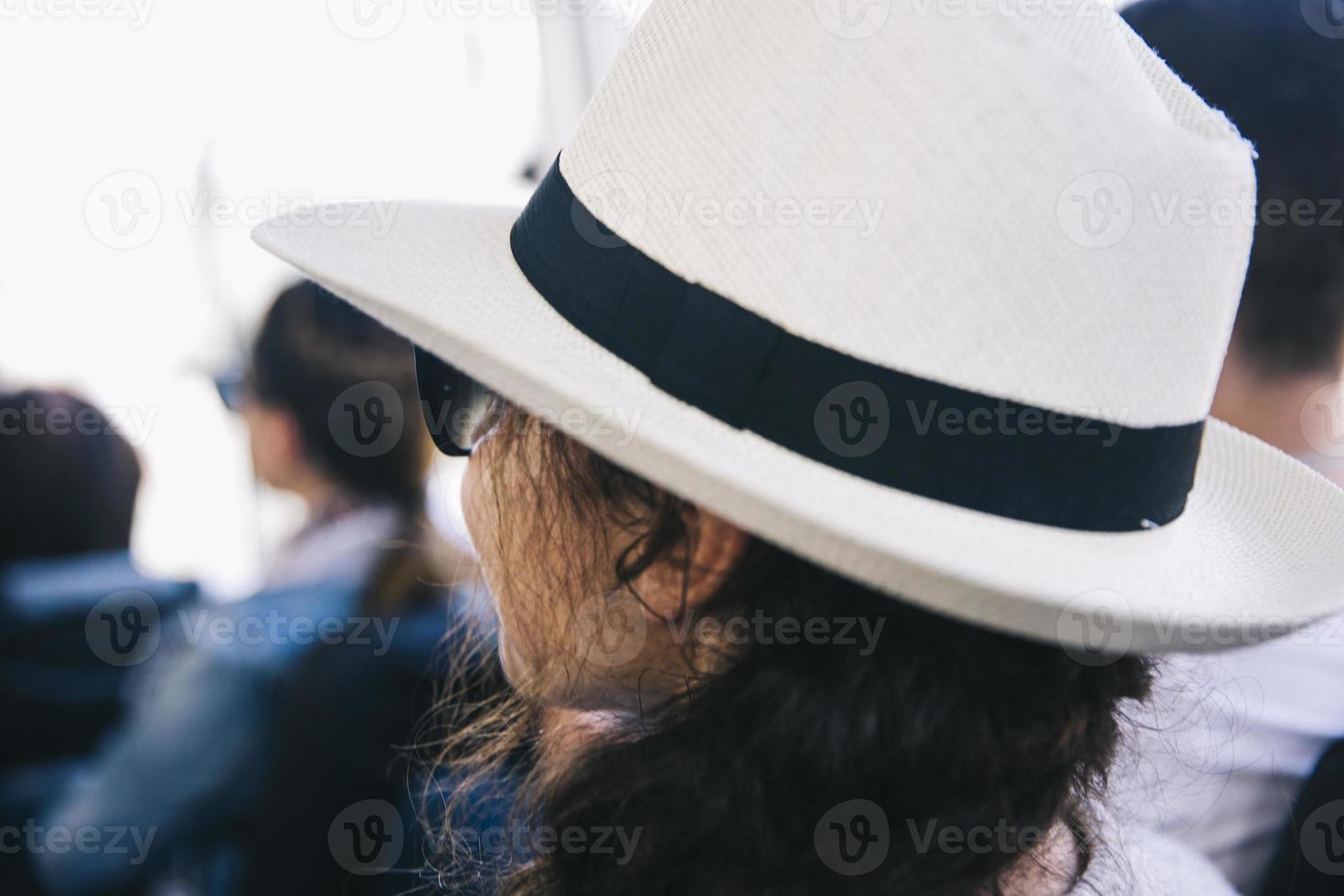 Back view at young woman with white hat photo