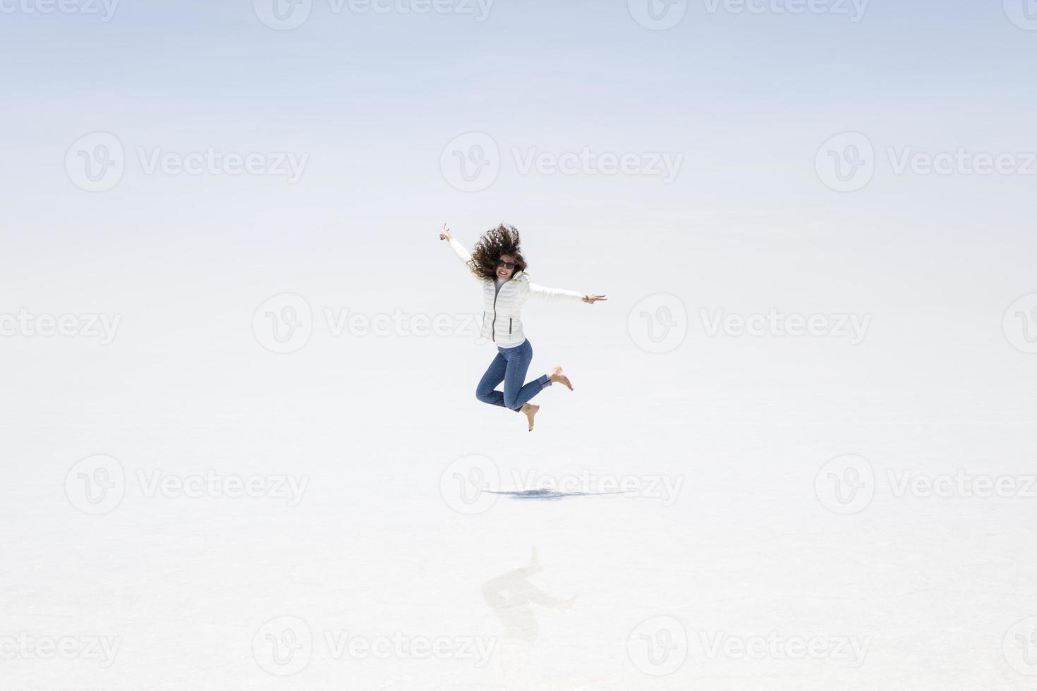Young woman at Salar de uyuni salt flat in Bolivia photo