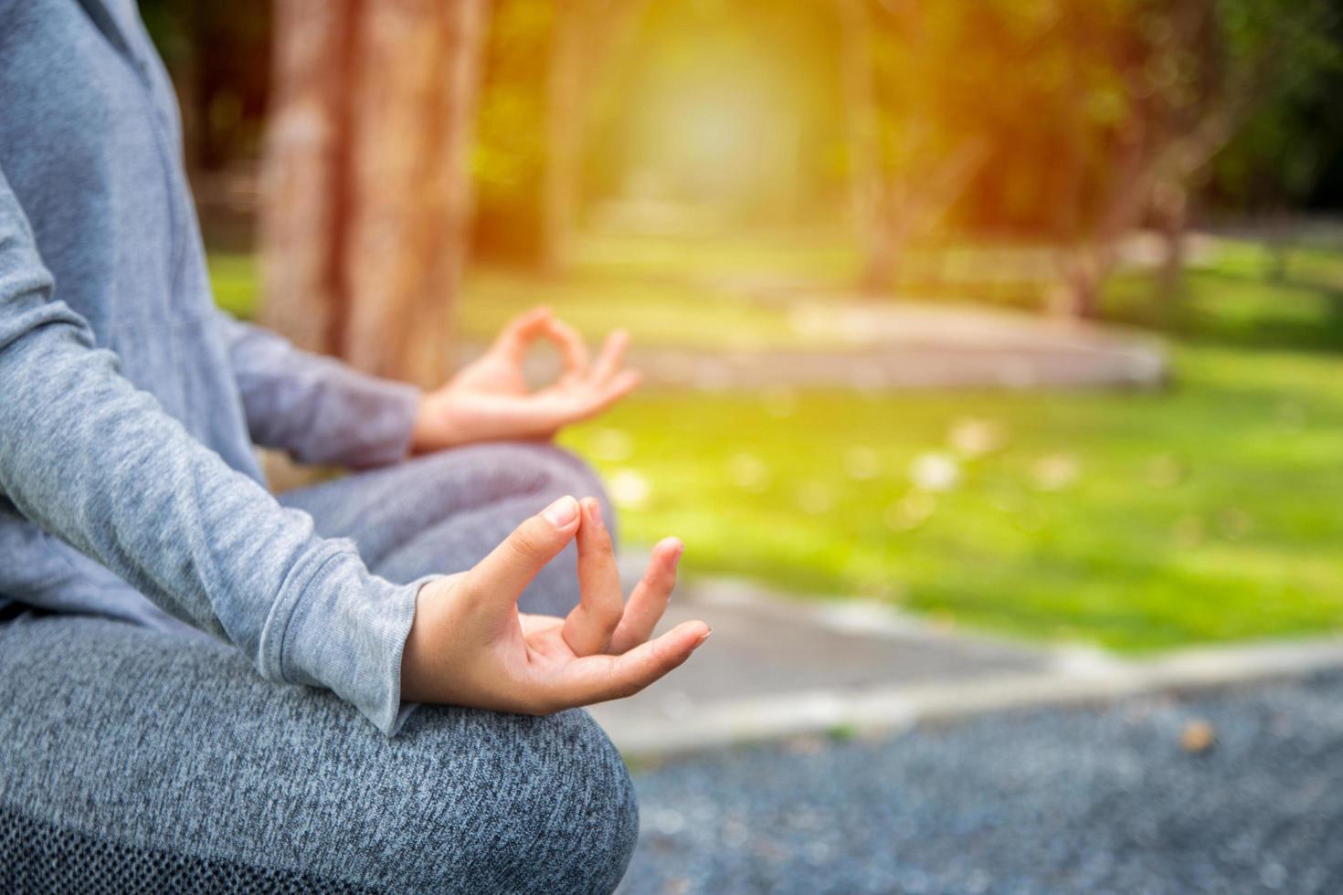 Young yoga woman meditating, relaxing in nature photo