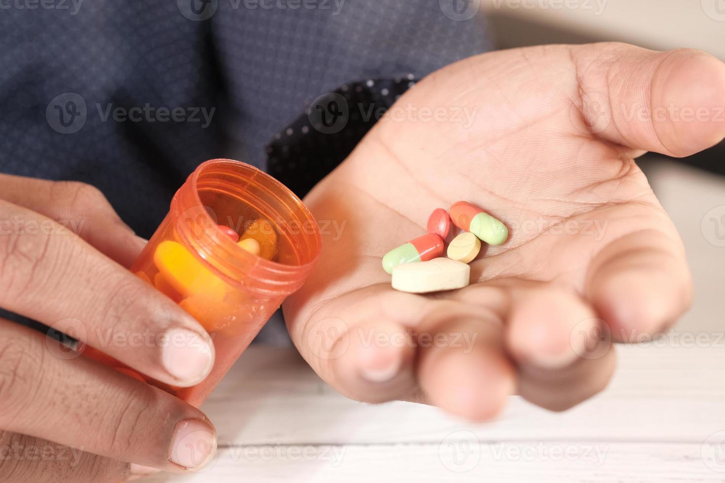 Man's hand with medicine photo