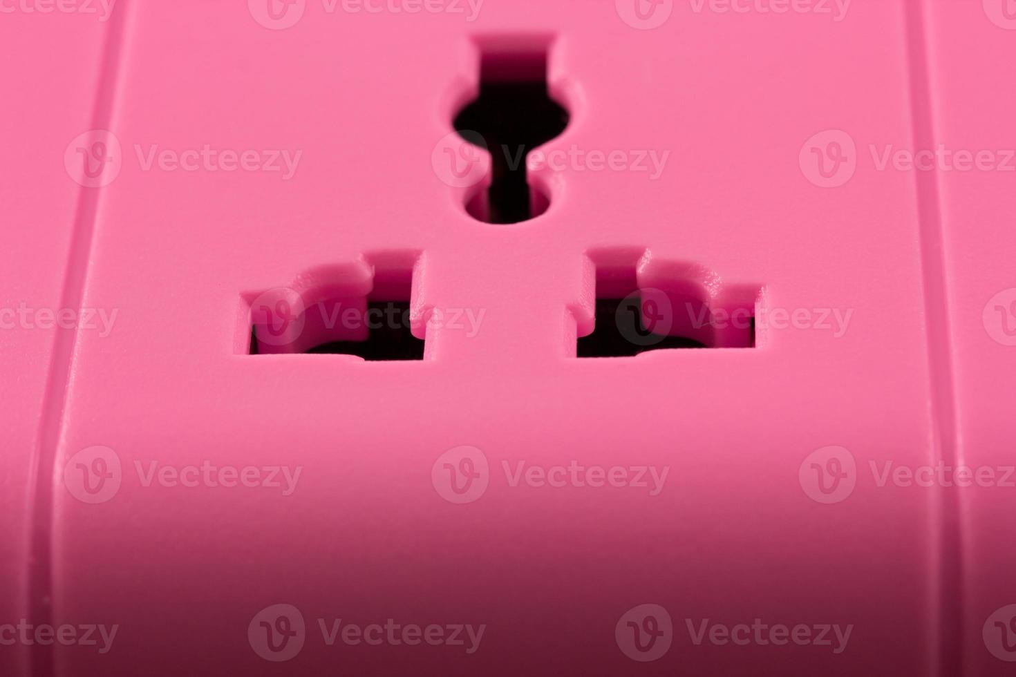 Close up picture of a pink outlet isolated on black photo