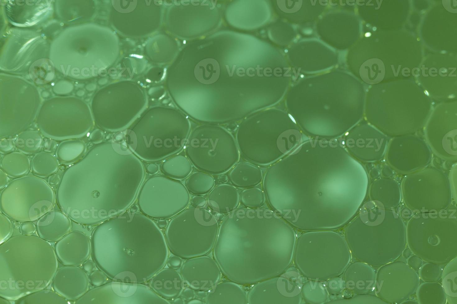 Macro shot of olive oil mixed in water photo