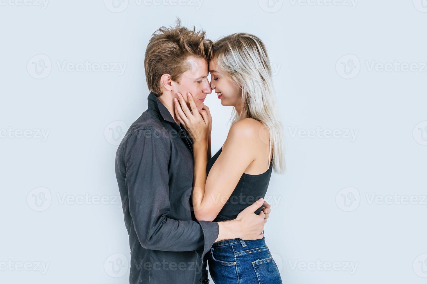 Portrait of happy young couple in love together in studio photo