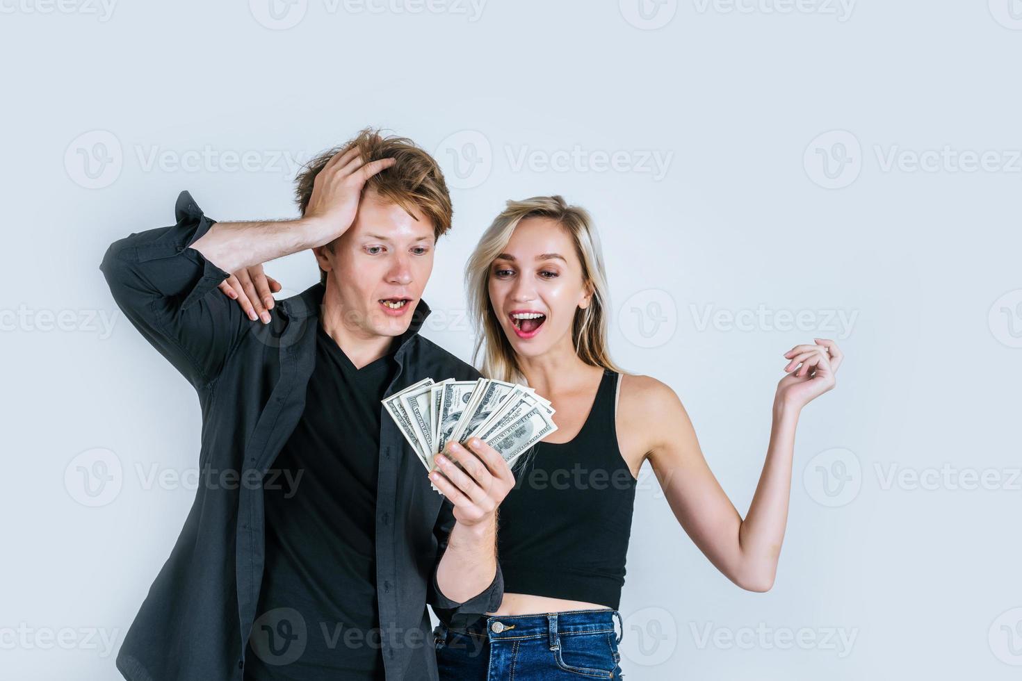 Happy couple showing dollar banknotes photo