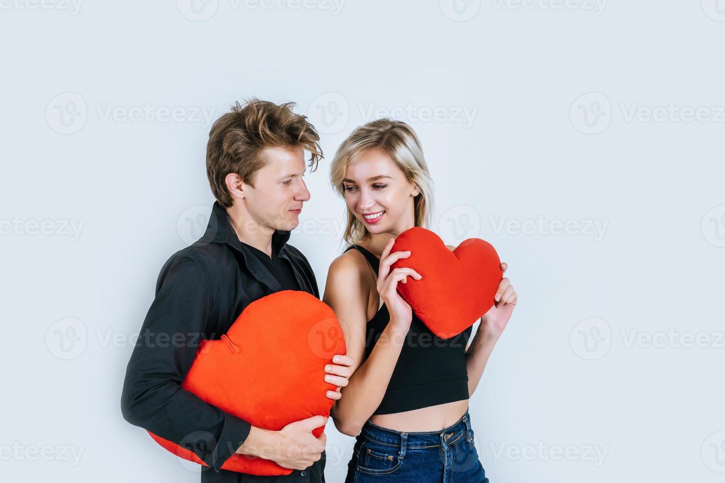 Happy couple loving together holding a red heart photo