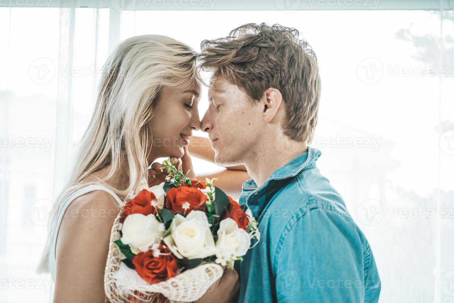 Happy couple embracing in the bedroom photo