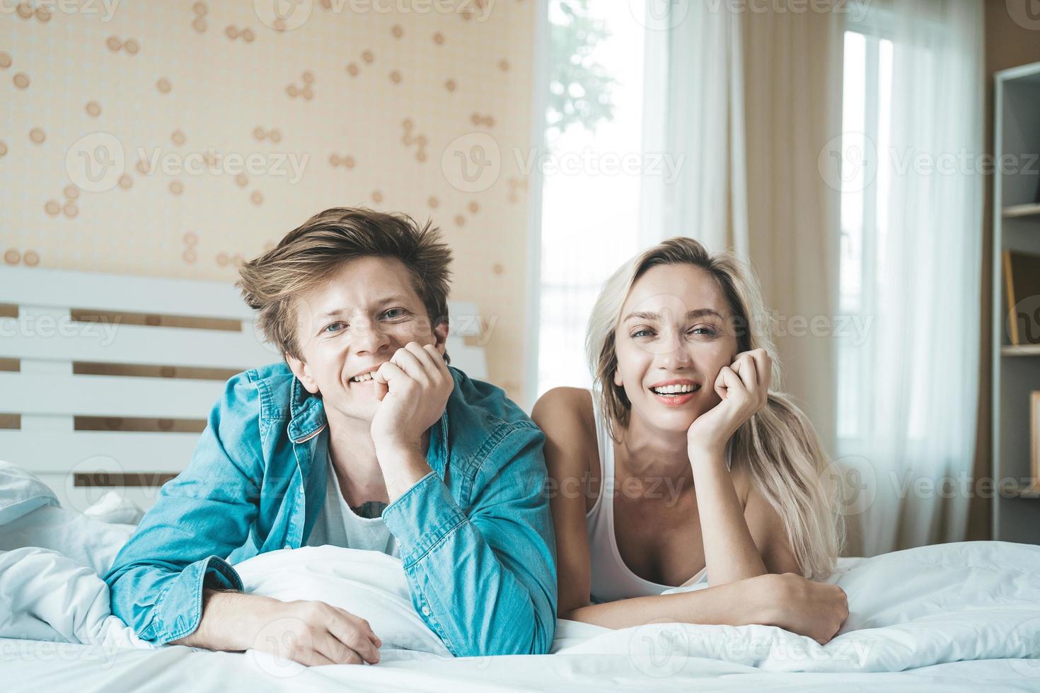 Happy couple together in the bedroom photo