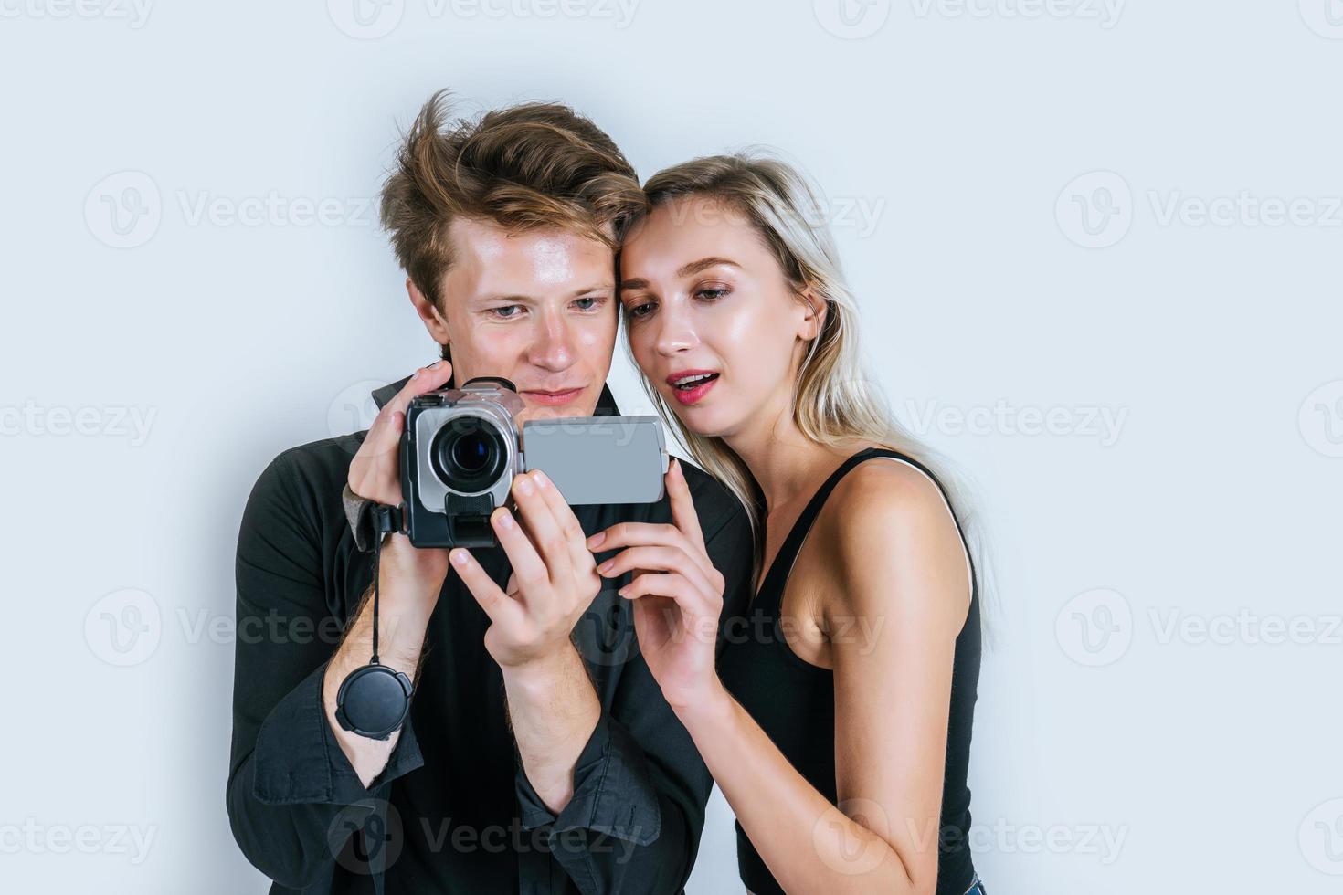 Happy portrait of couple holding microphones and singing photo