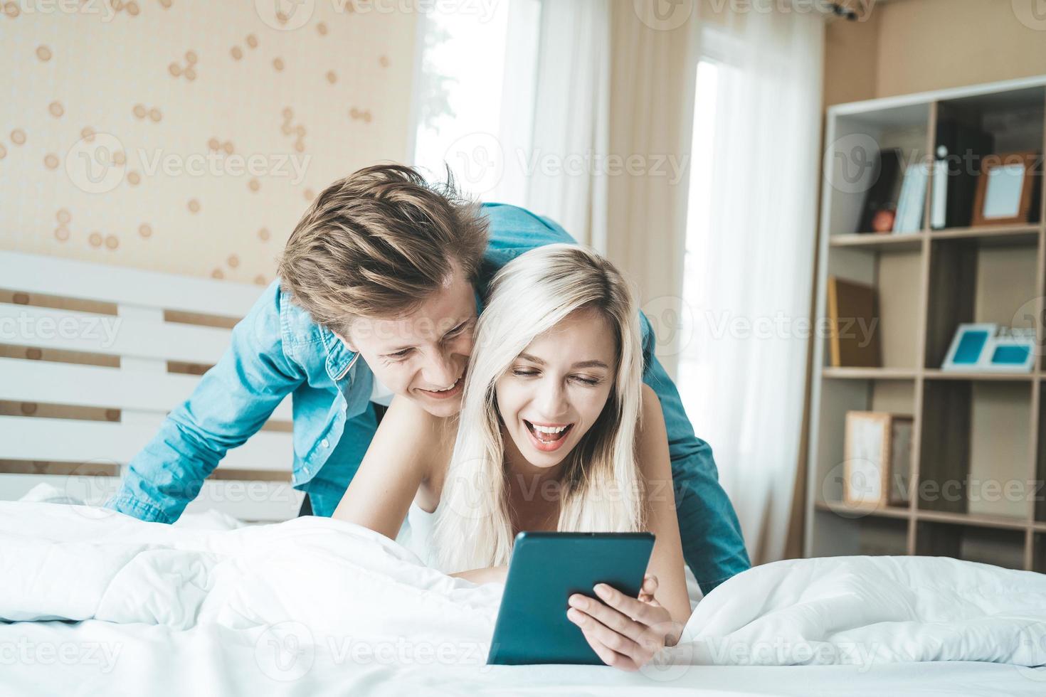 Happy couple together in the bedroom photo