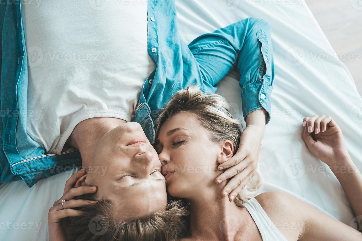 Happy couple together in the bedroom photo