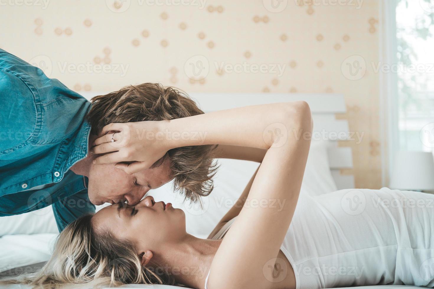 Happy couple together in the bedroom photo