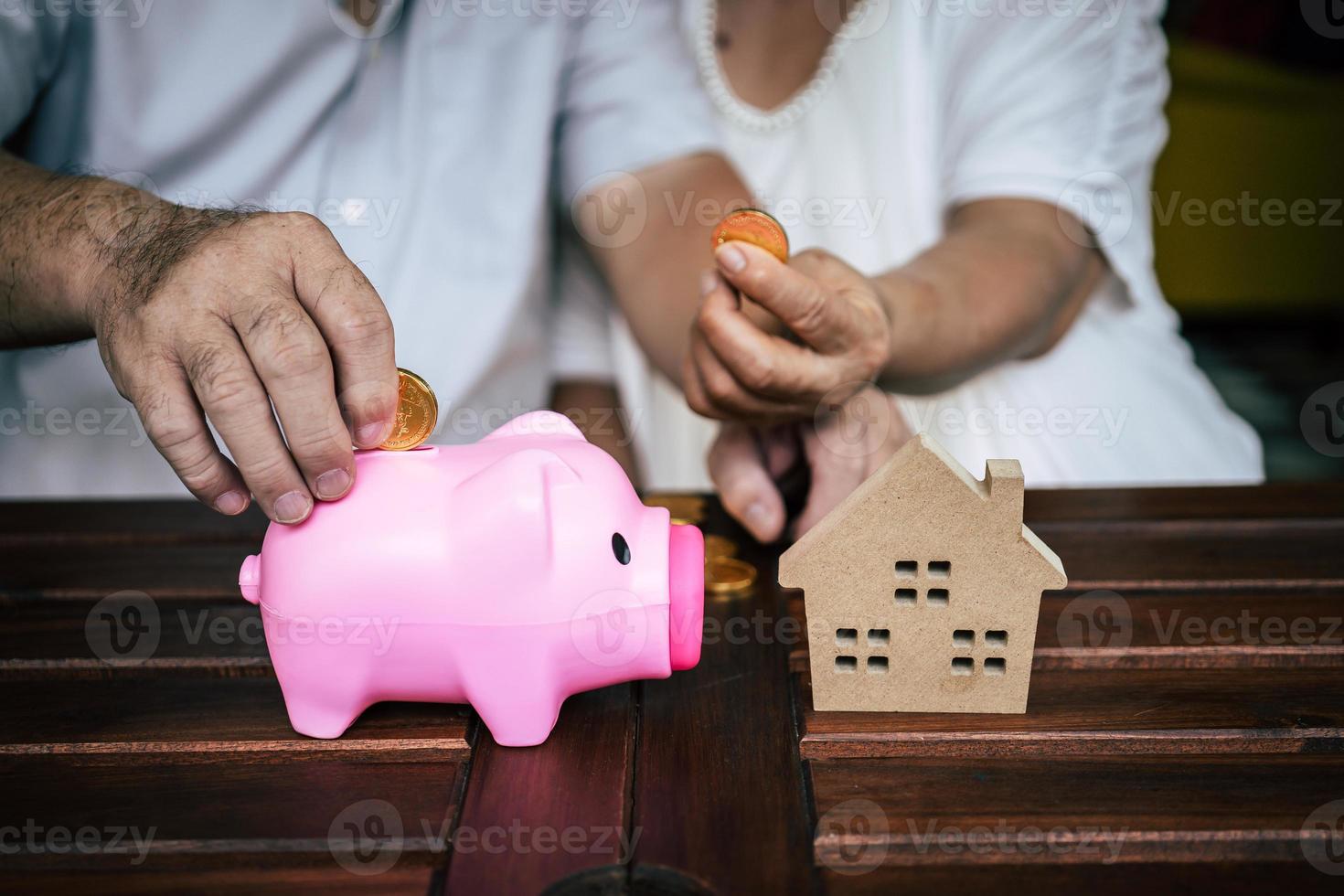 Elderly couple talking about finances with piggy bank photo