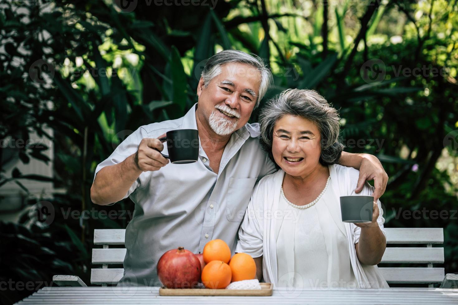 pareja de ancianos jugando y comiendo fruta foto