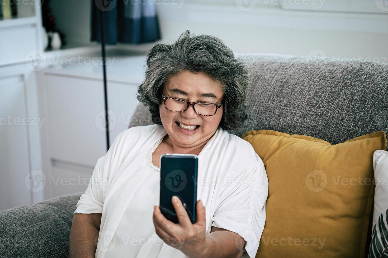 Senior woman on video call with family photo