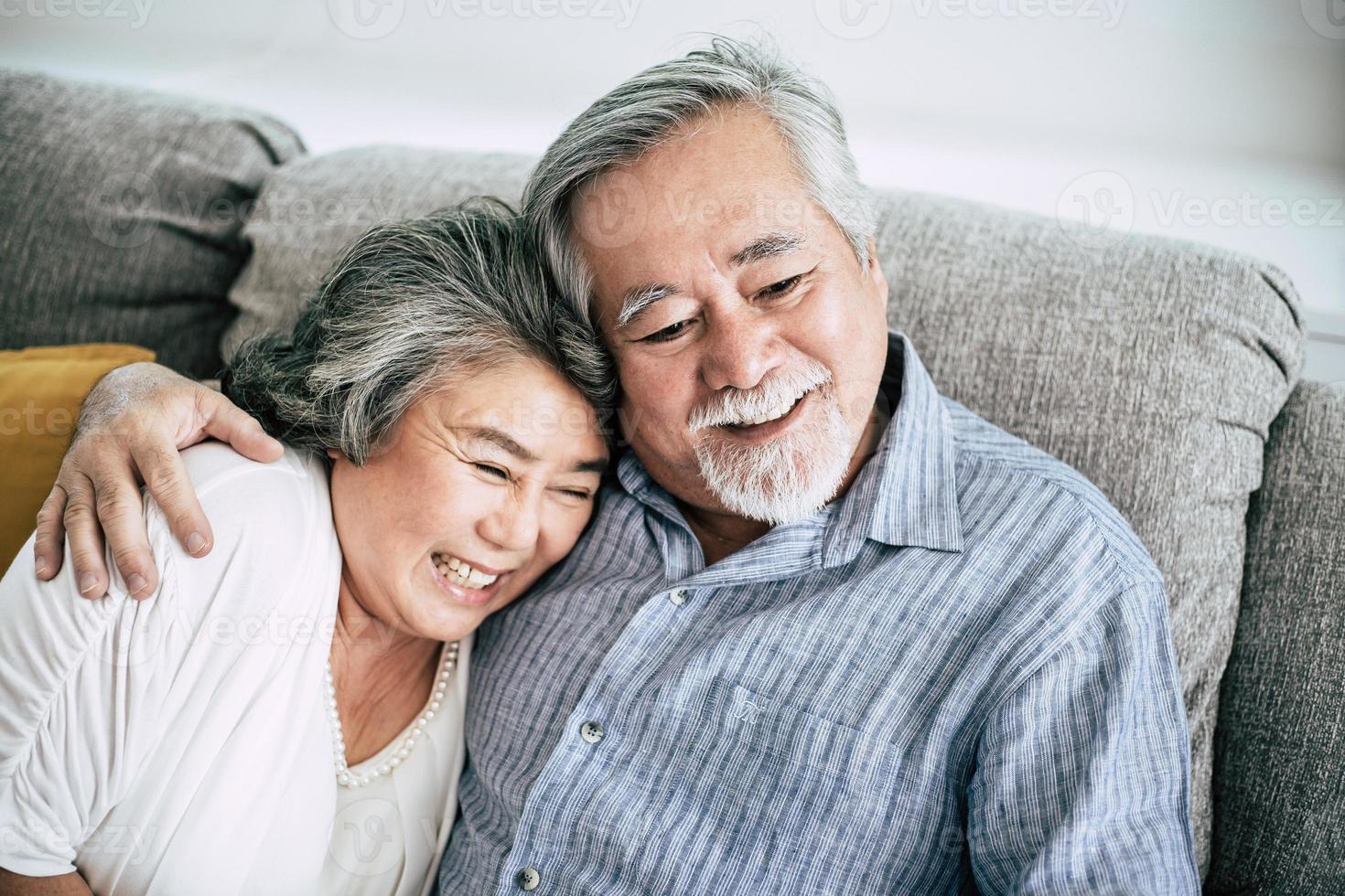Senior couple playing together in living room photo