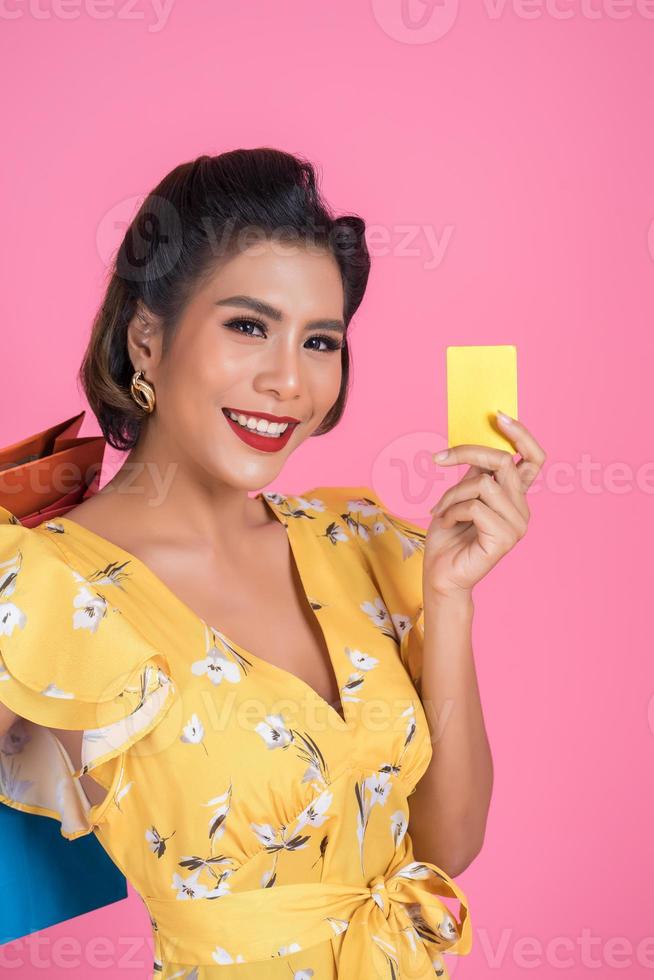 Fashionable woman with shopping bags and credit card photo