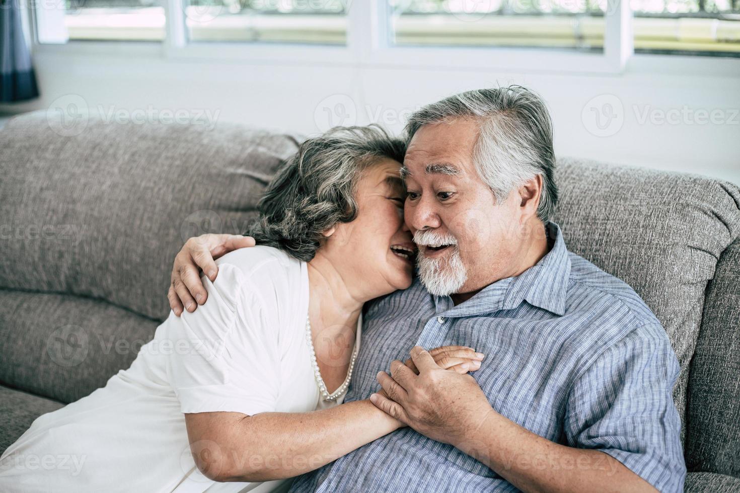 Senior couple playing together in living room photo